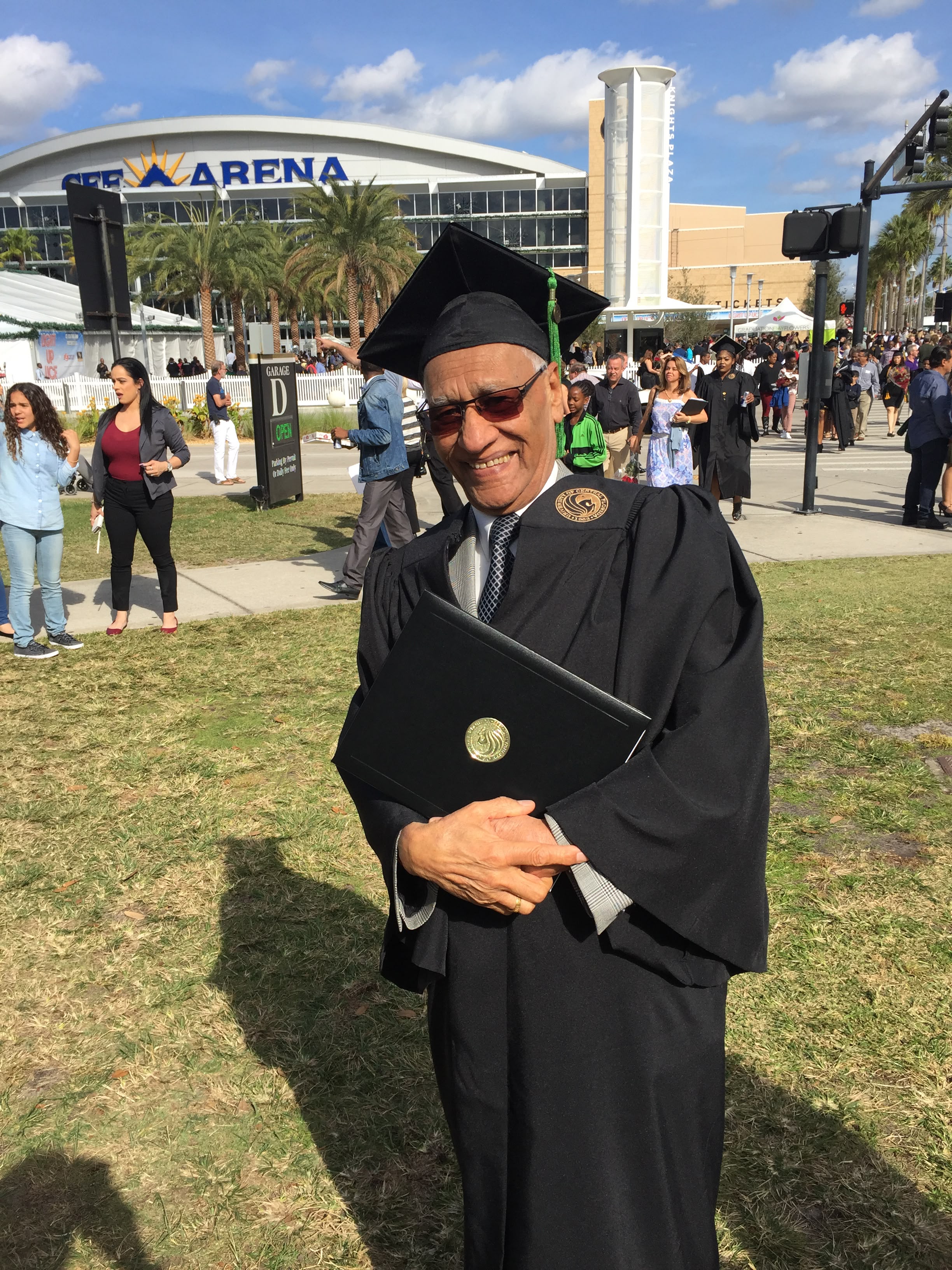 Sushil Gupta smiling in a graduation cap and gown
